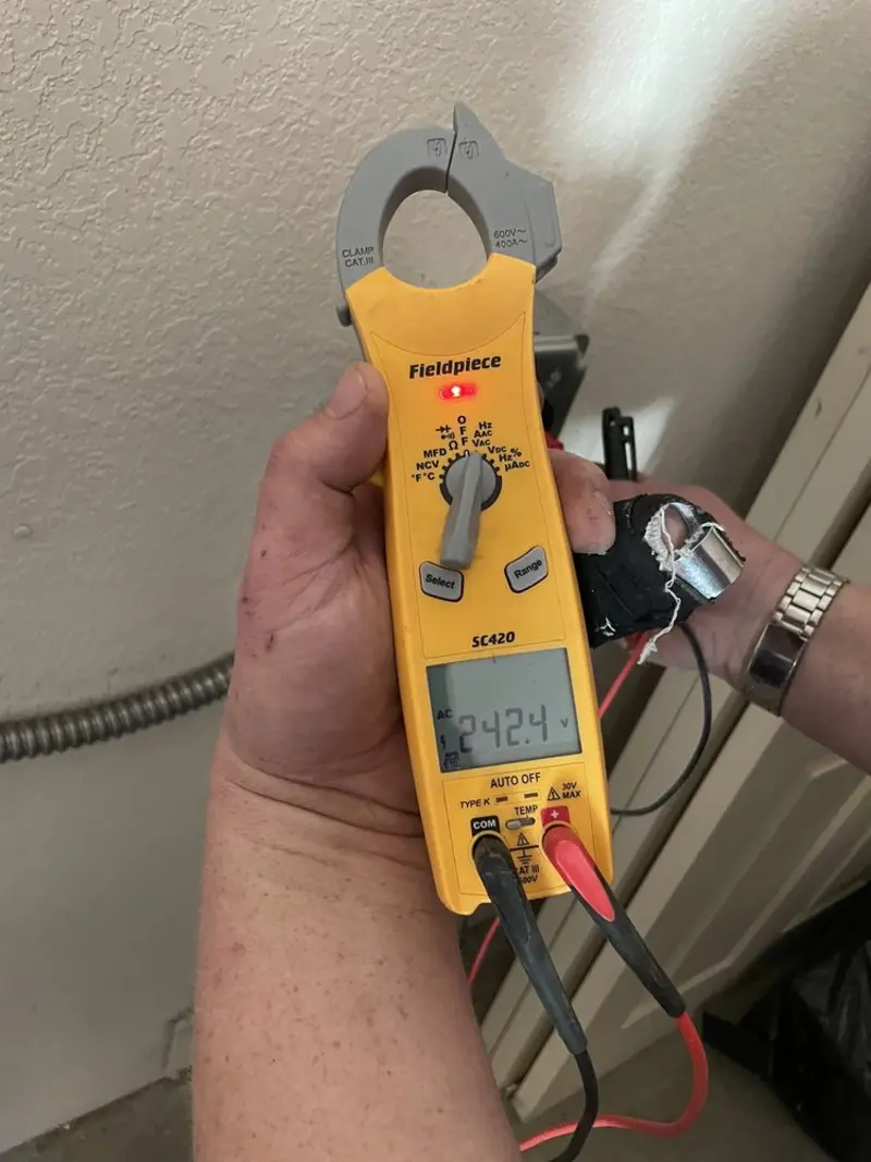 Voltage testing with clamp meter during Recessed Lighting Installation in Pelham Manor